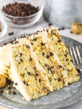 A Piece of Chocolate Chip Cake on a Plate in Front of a Bowl of Mini Chocolate Chips