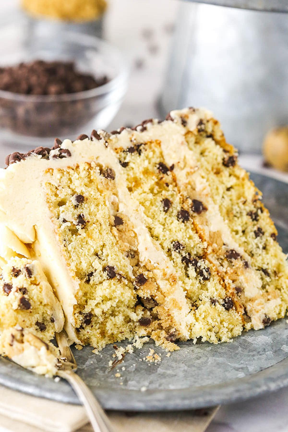 A Slice of Chocolate Chip Cookie Dough Layer Cake on a Metal Plate