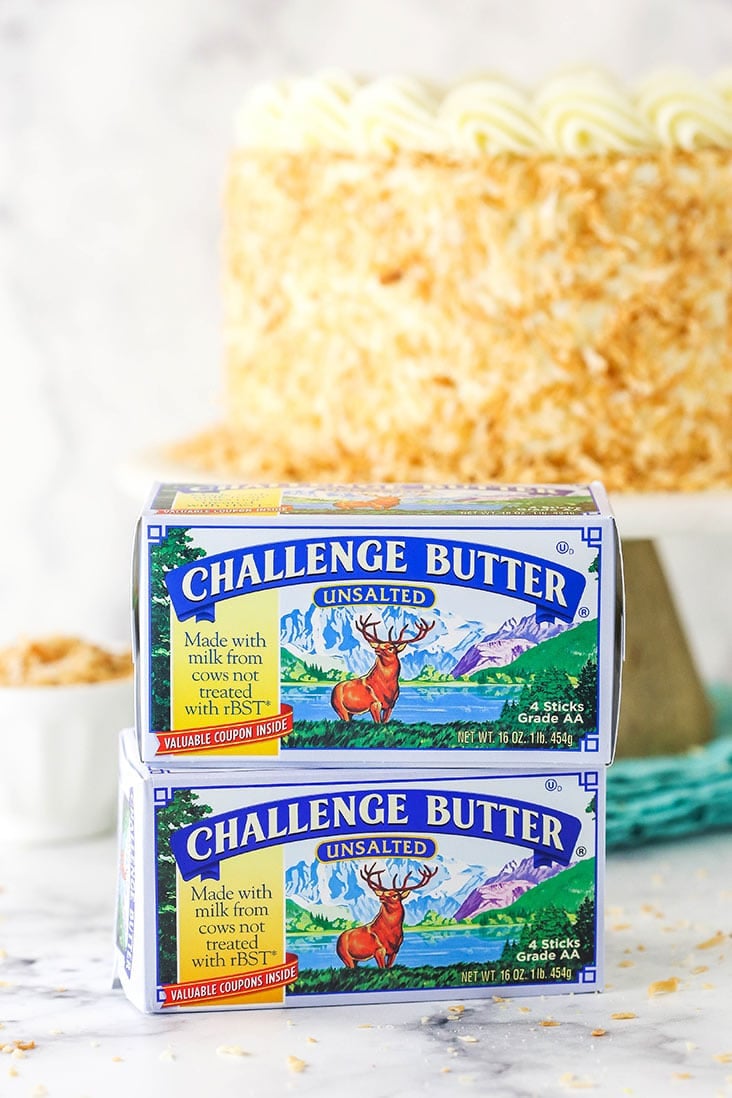 two packages of challenge butter stacked in front of cake