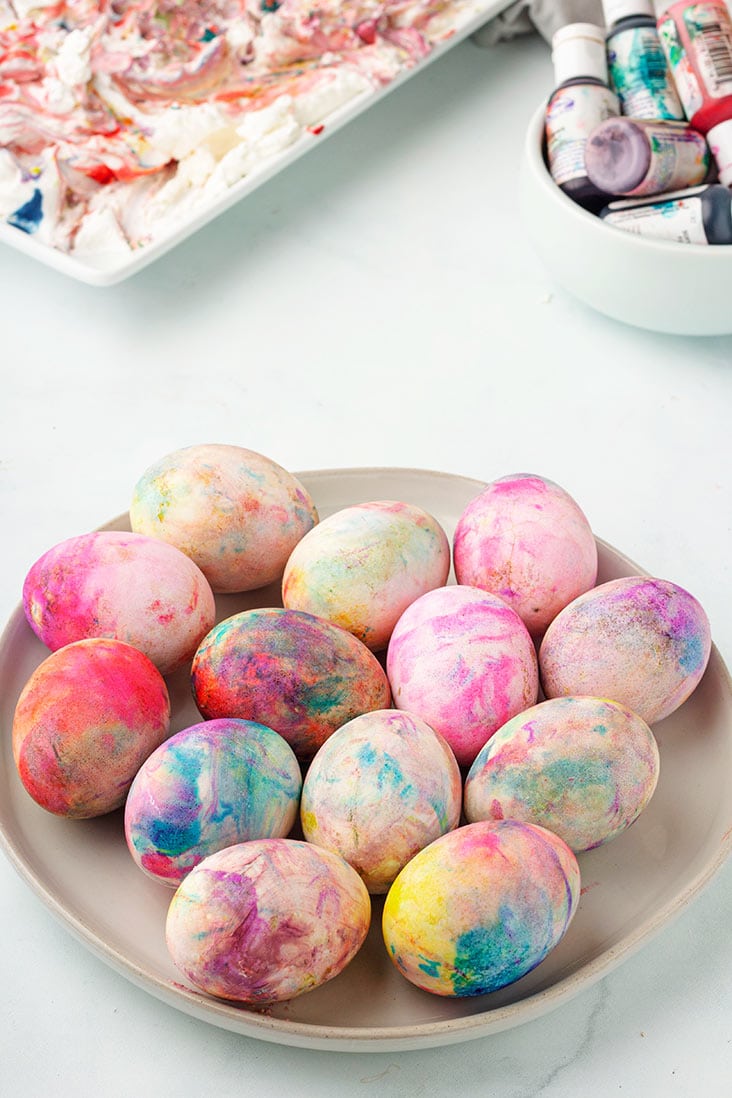 finished eggs on cream plate with coloring and cool whip in the background