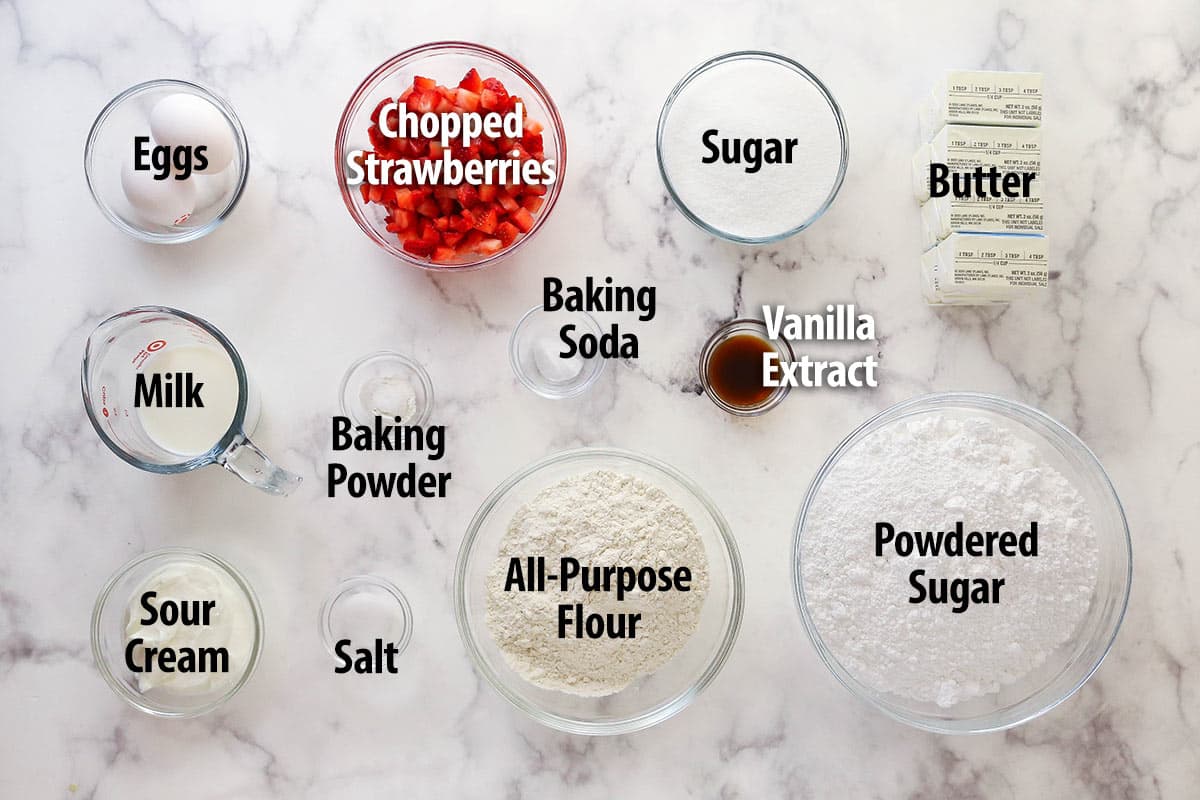 ingredients for fresh strawberry cupcakes on marble background
