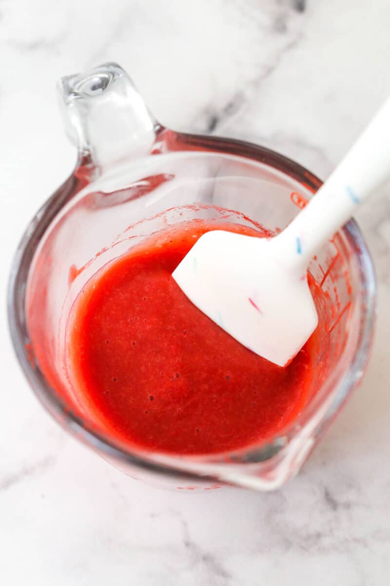 reduced strawberry puree in measuring cup