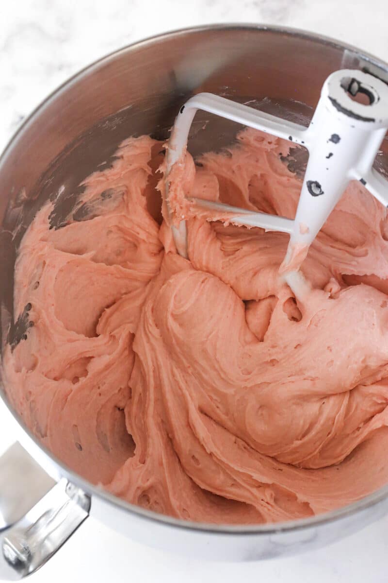 strawberry buttercream in mixing bowl with beater blade