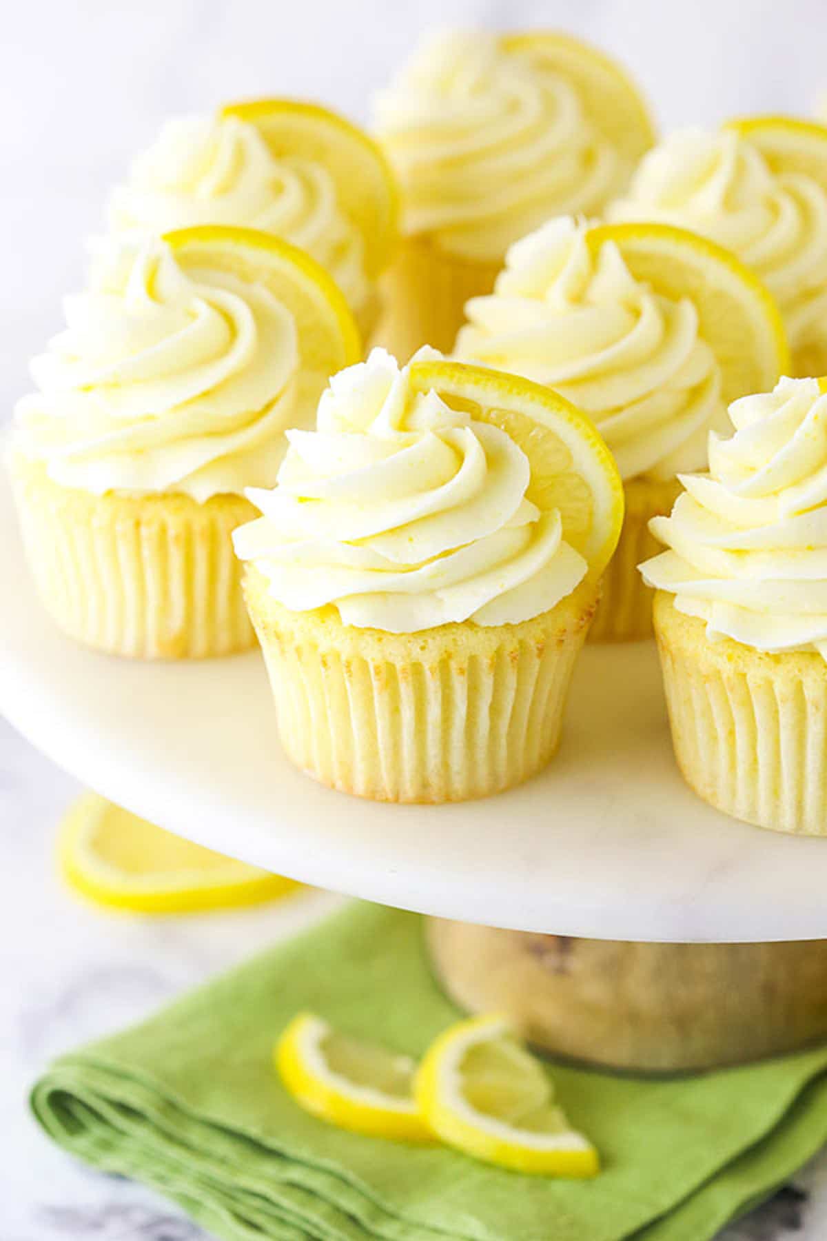 A Cake Stand Holding a Batch of Lemon Cupcakes Garnished with Lemon Slices