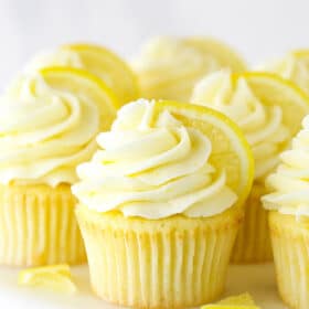 Lemon Cupcakes on a Cake Stand with Slices of Fresh Lemon