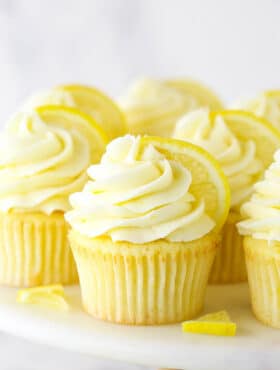 Lemon Cupcakes on a Cake Stand with Slices of Fresh Lemon