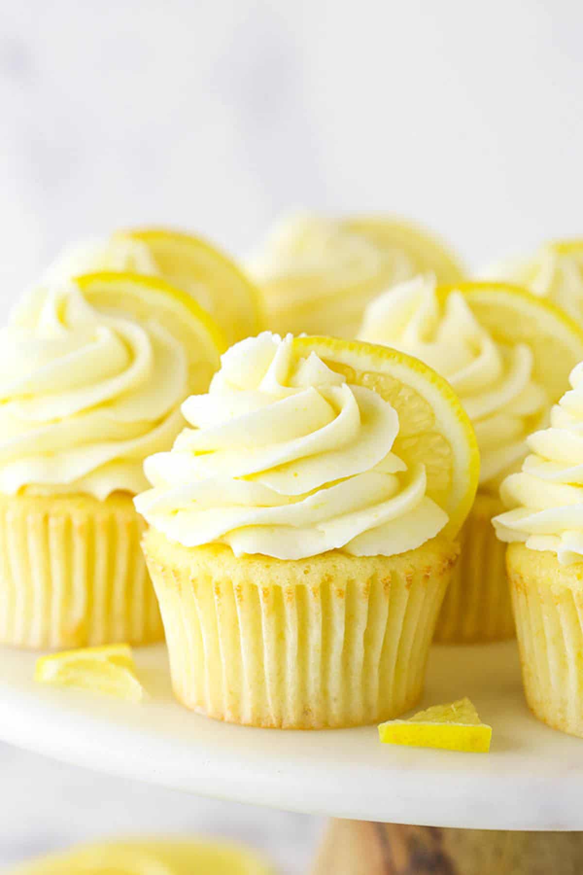 Lemon Cupcakes on a Cake Stand with Slices of Fresh Lemon