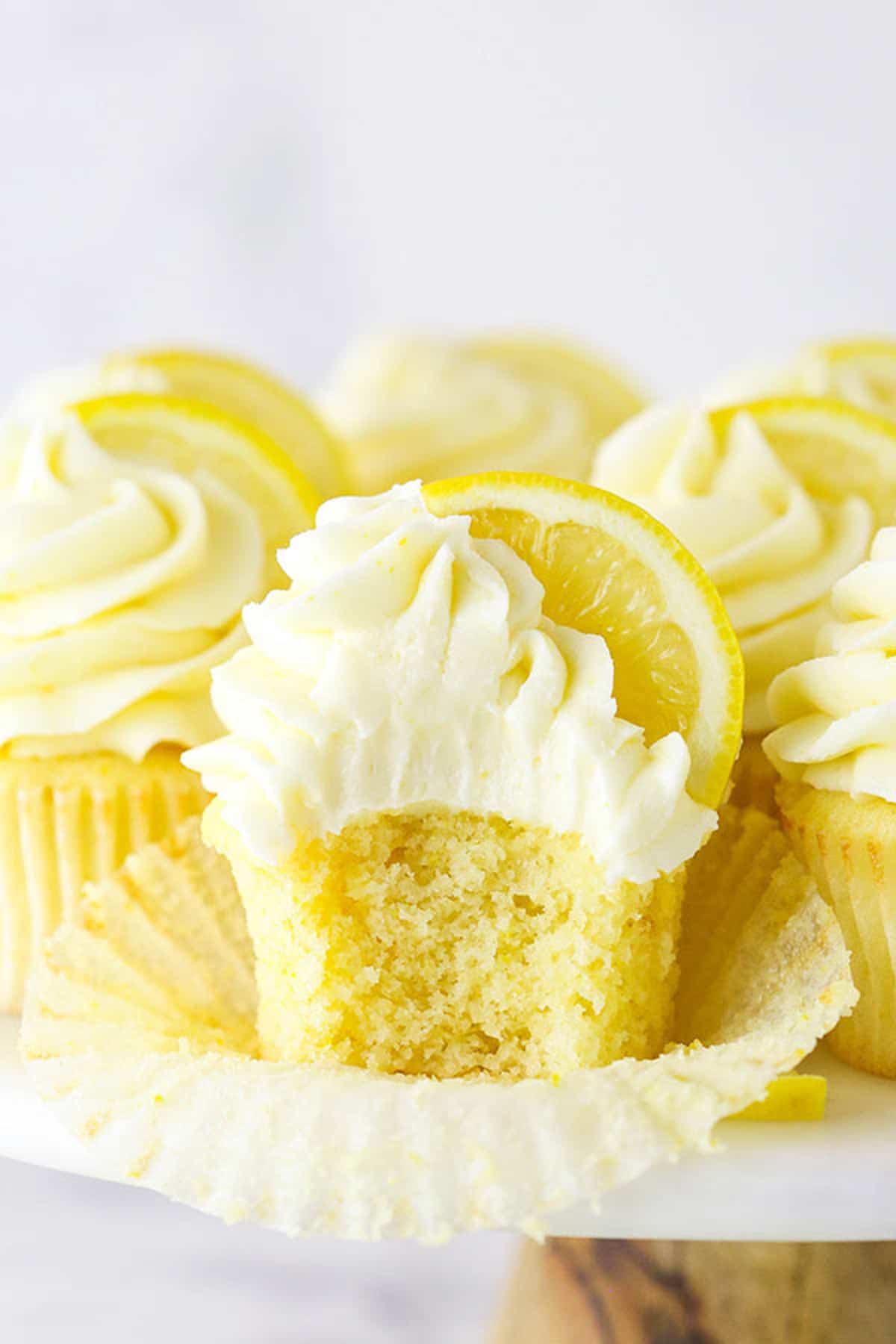 A Frosted Lemon Cupcake with One Bite Taken Out