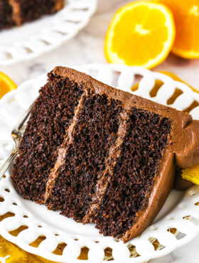 orange chocolate cake slice on a white plate