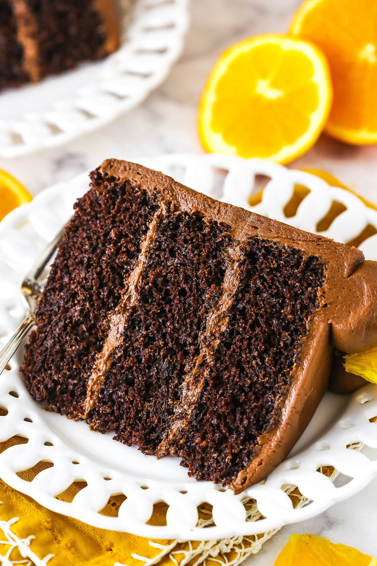 orange chocolate cake slice on a white plate