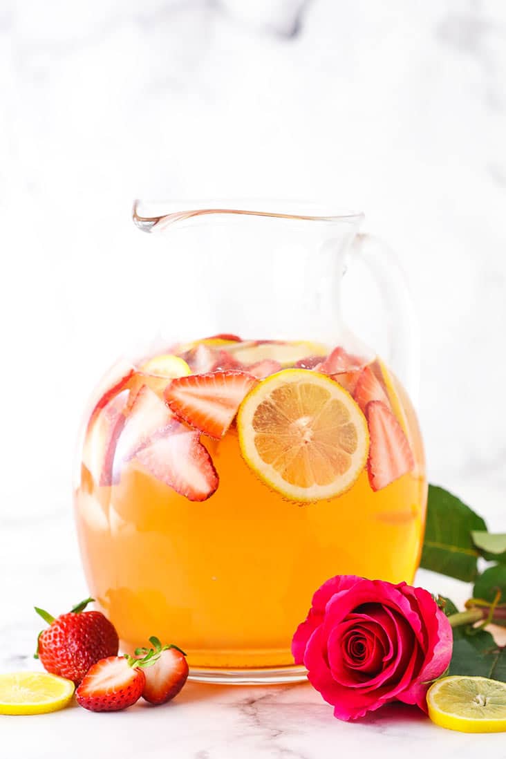 A pitcher of Rosewater Rosé Sangria with a red rose in front