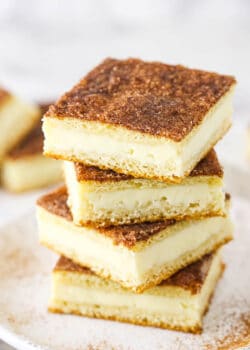 A Pile of Sopapilla Bars on a Plate Dusted with Cinnamon Sugar