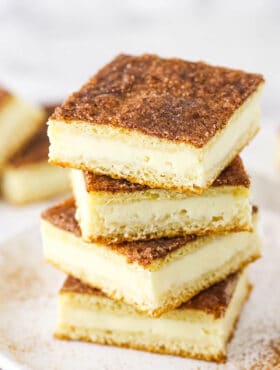 A Pile of Sopapilla Bars on a Plate Dusted with Cinnamon Sugar