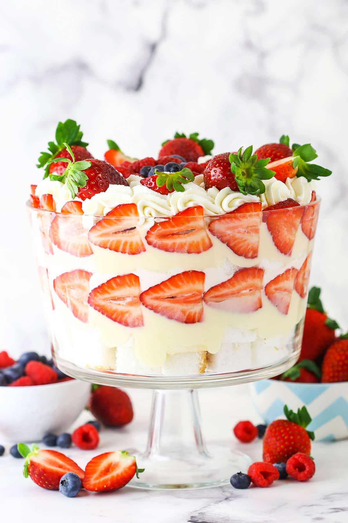 side image of trifle in a clear trifle dish with strawberries as decoration