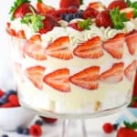 Triple Berry Trifle in clear trifle dish with berries around the bottom