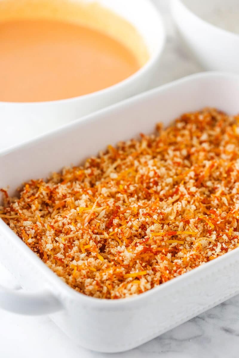 panko mixture in white dish with buffalo mixture in background