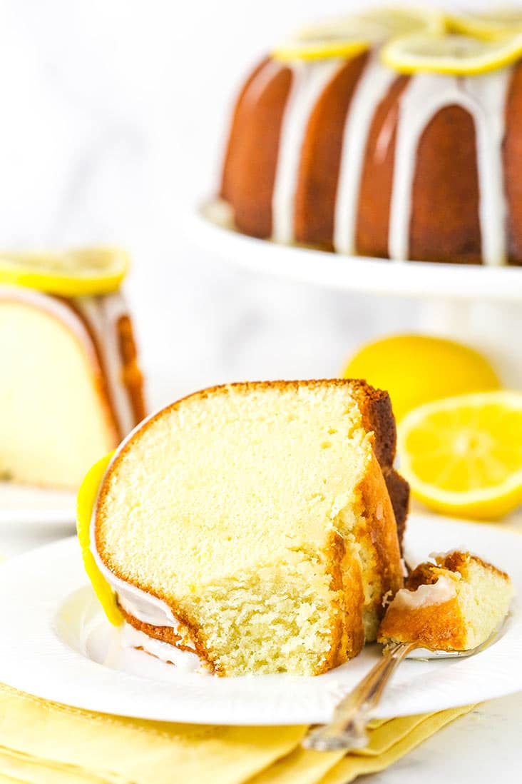 A slice of lemon pound cake on a white plate.