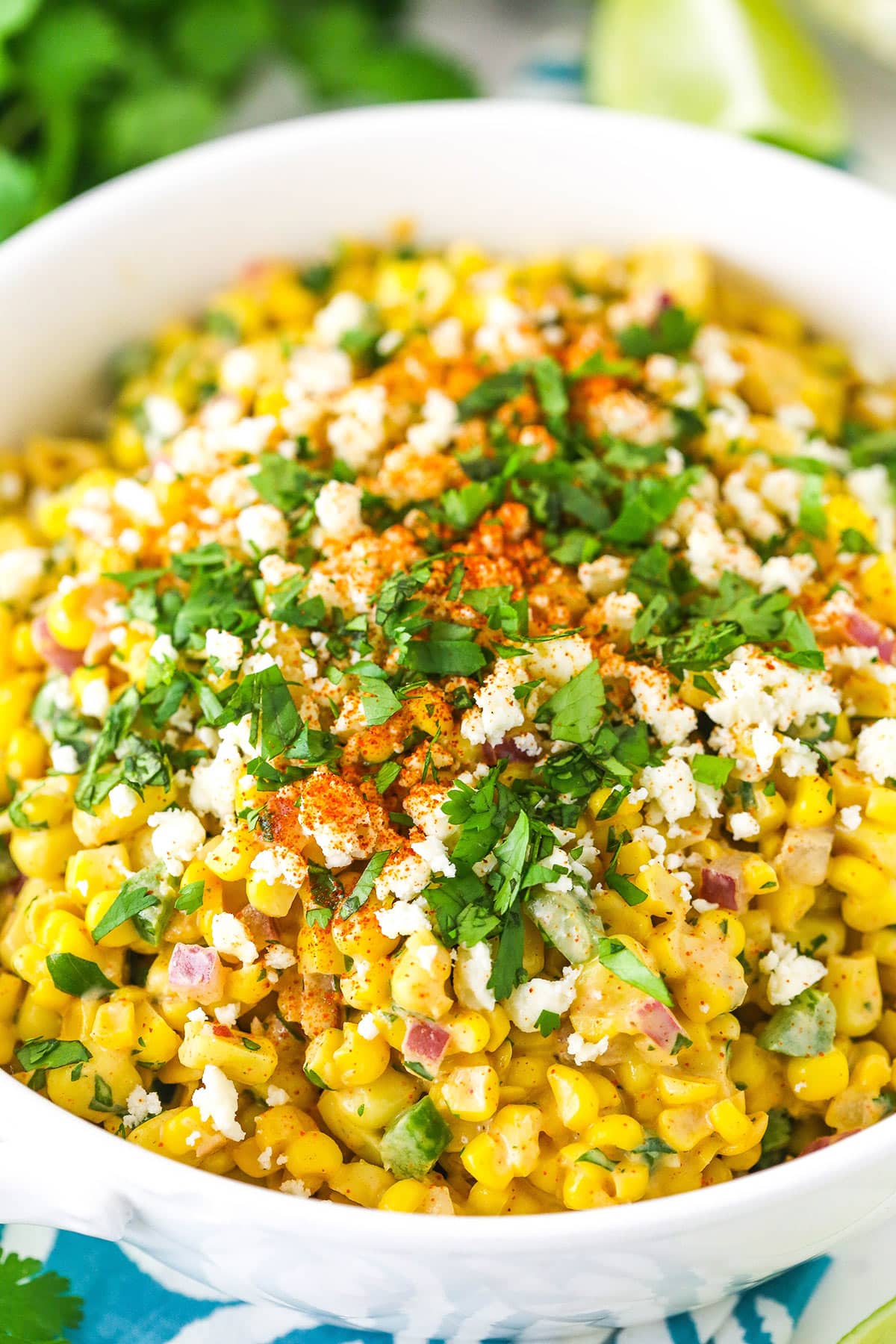 Mexican street corn salad is creamy, zesty, and smoky with just the right amount of spice to complement the sweetness of the corn. Um, yum! Close-up image of mexican street corn salad in a bowl.