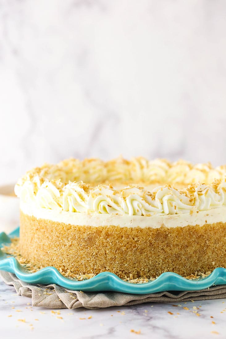 A no bake toasted coconut cheesecake with homemade vanilla wafer crust on a blue plate.