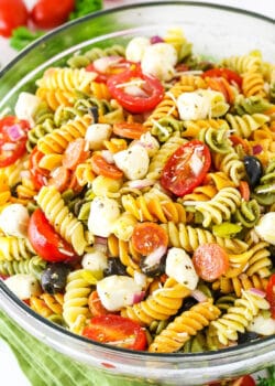 A bowl of Italian pasta salad with fresh mozzarella, tomato, olives, and pepperoni