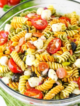 A bowl of Italian pasta salad with fresh mozzarella, tomato, olives, and pepperoni