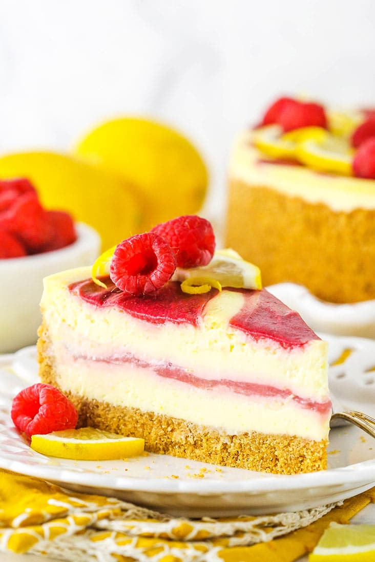 A slice of lemon cheesecake with raspberry swirl