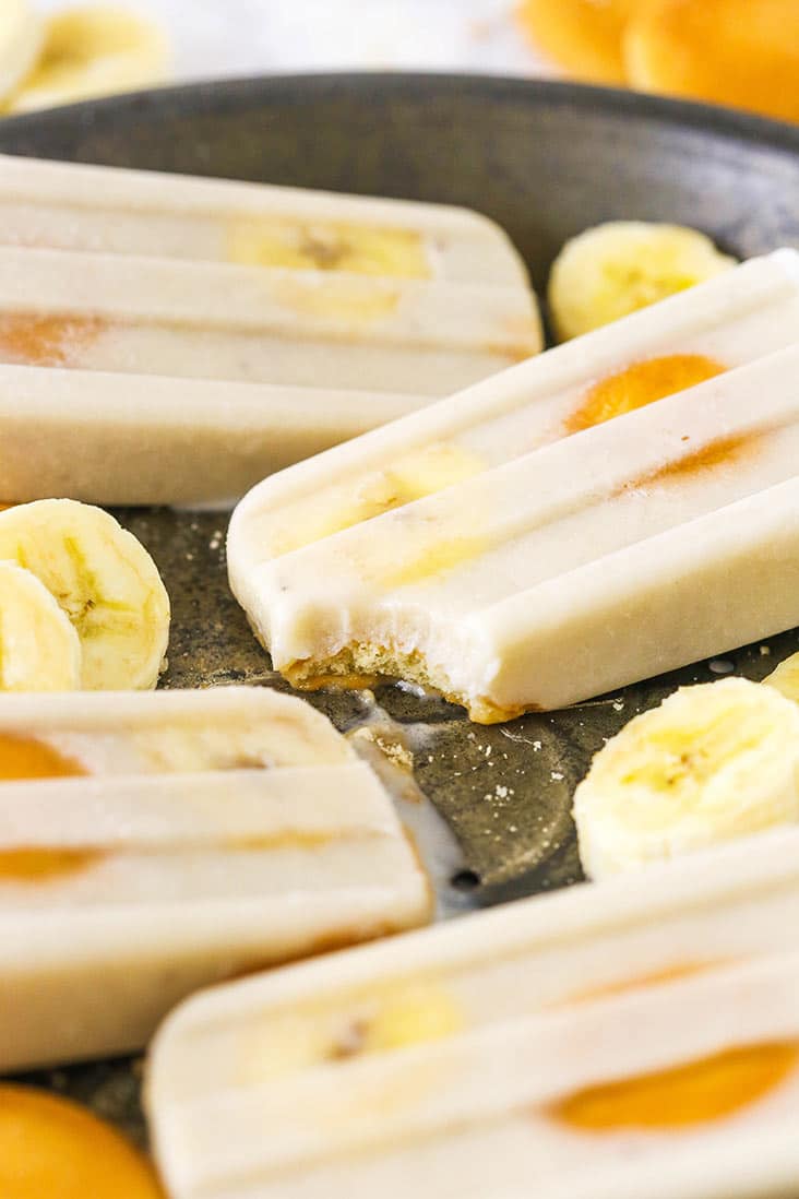 Banana popsicles with a bite missing from one