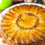 Apple upside down cake on a white serving dish