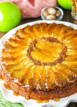 Apple upside down cake on a white serving dish