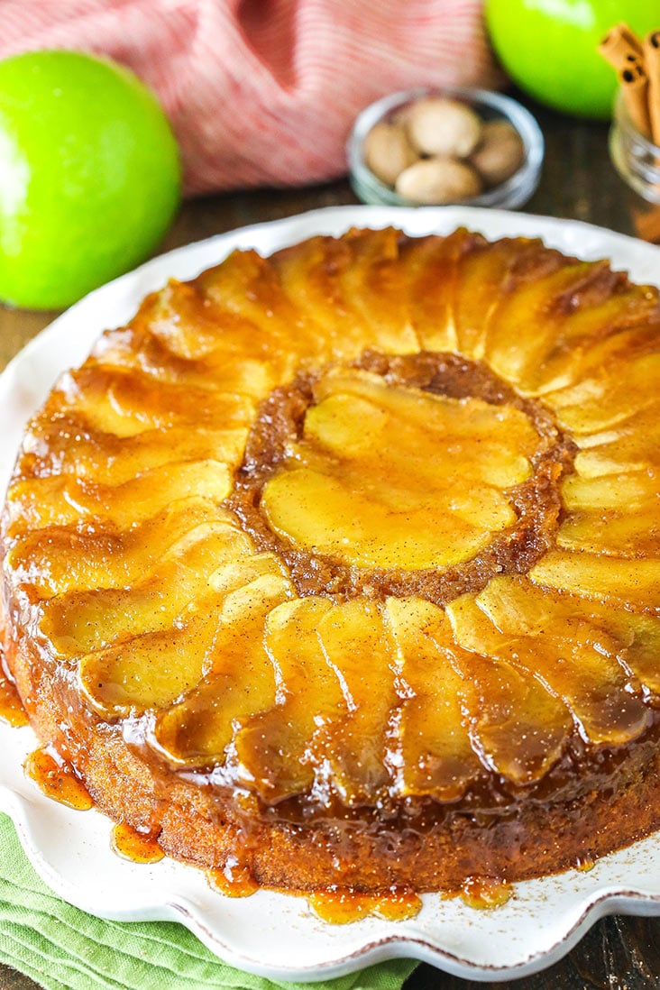 Apple upside down cake on a white serving dish