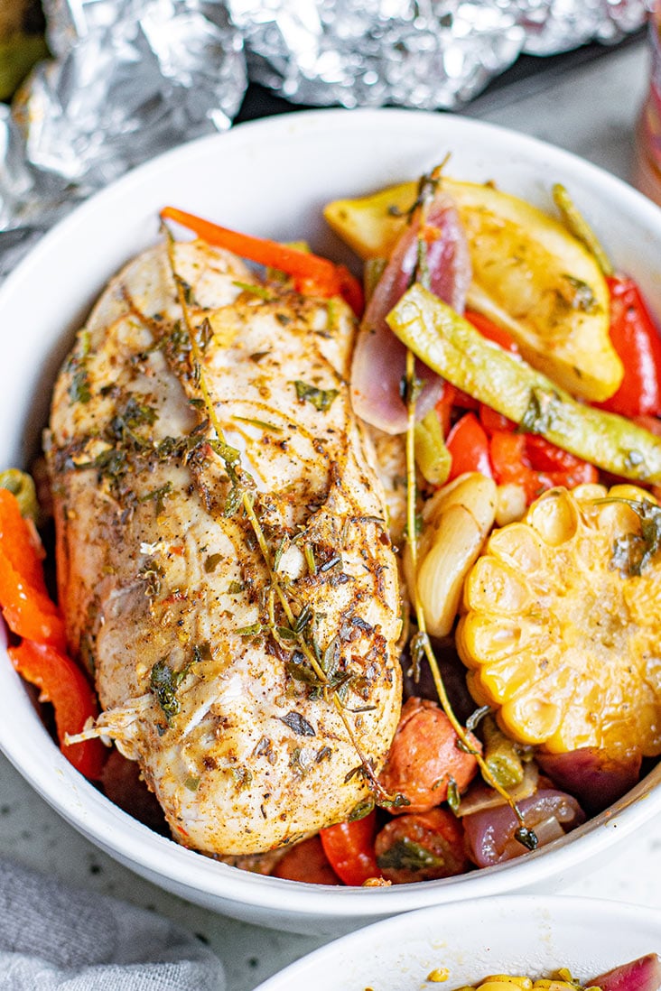 cooked foil packed contents in a white bowl