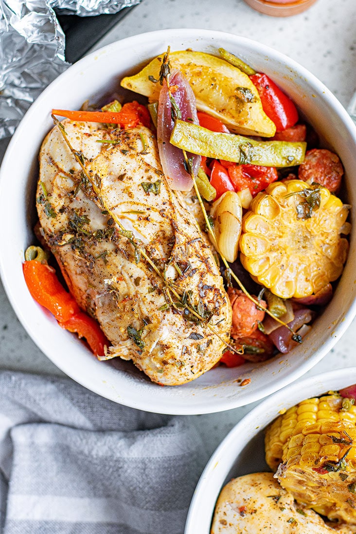 chicken and sausage foil packet meal in white bowl