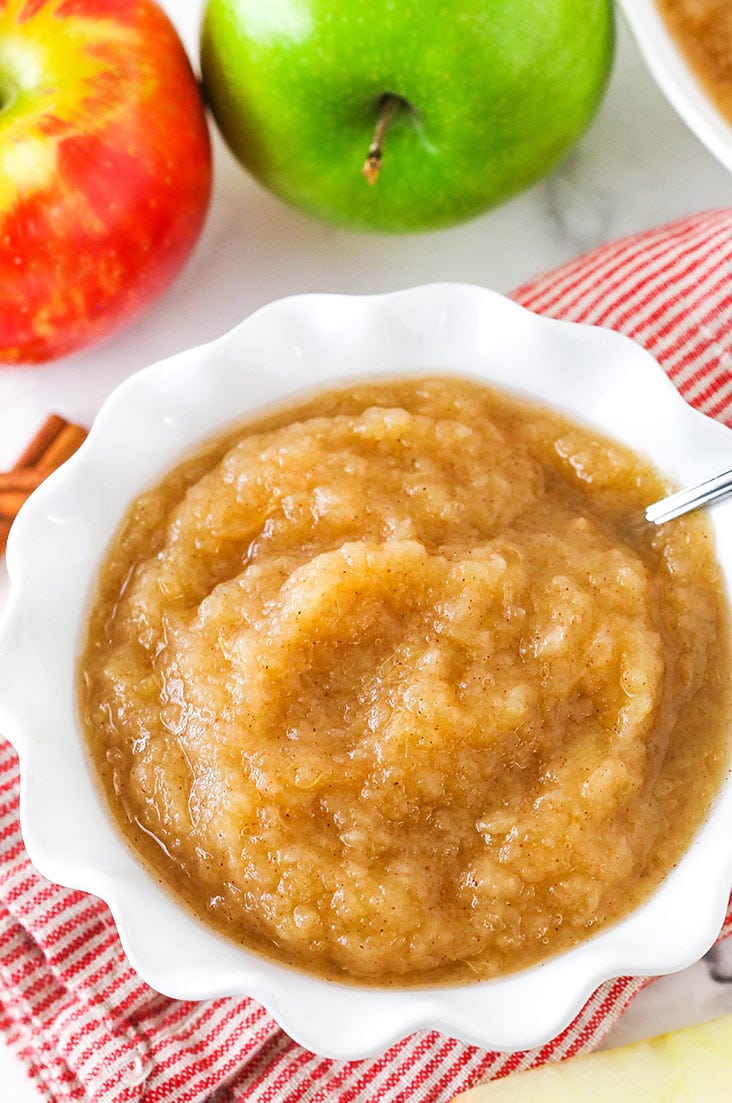 A white bowl of Instant Pot Applesauce with a spoon