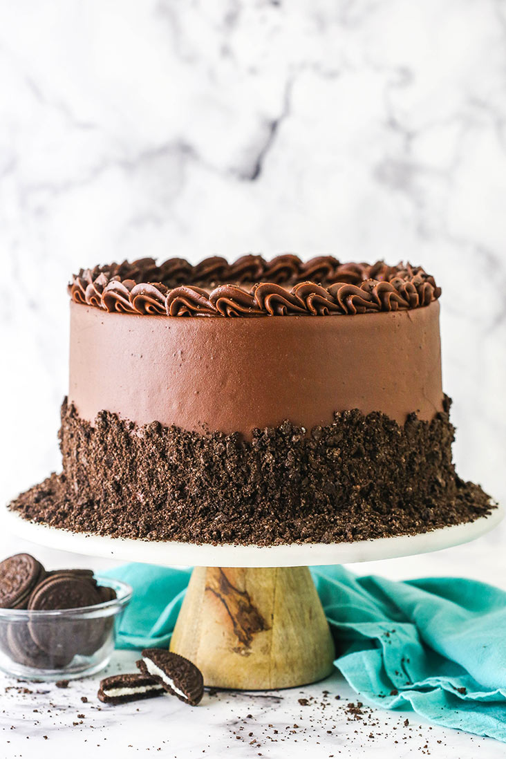 A decadent Oreo Cookies and Cream Cheesecake on a white serving platter