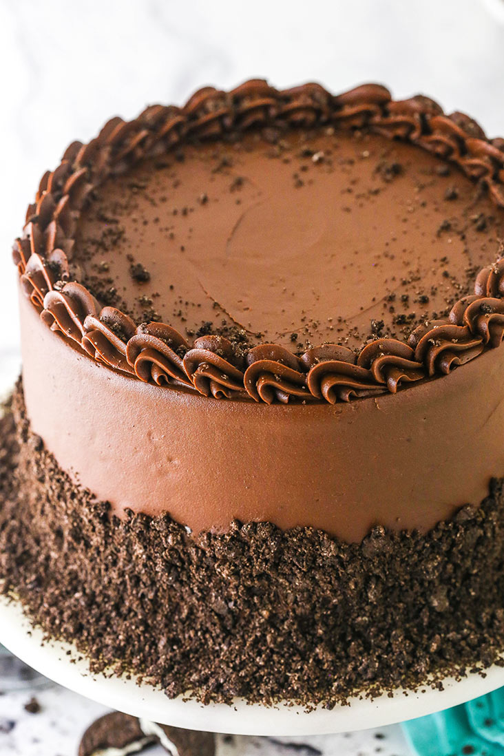 An Oreo Cookies and Cream Cheesecake Cake with chocolate buttercream frosting