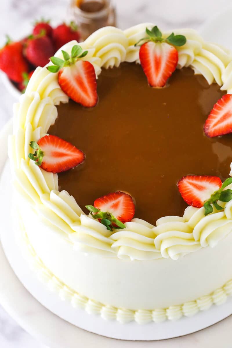 view of top of Strawberry Dulce De Leche Cake with dulce de leche and stawberries on top