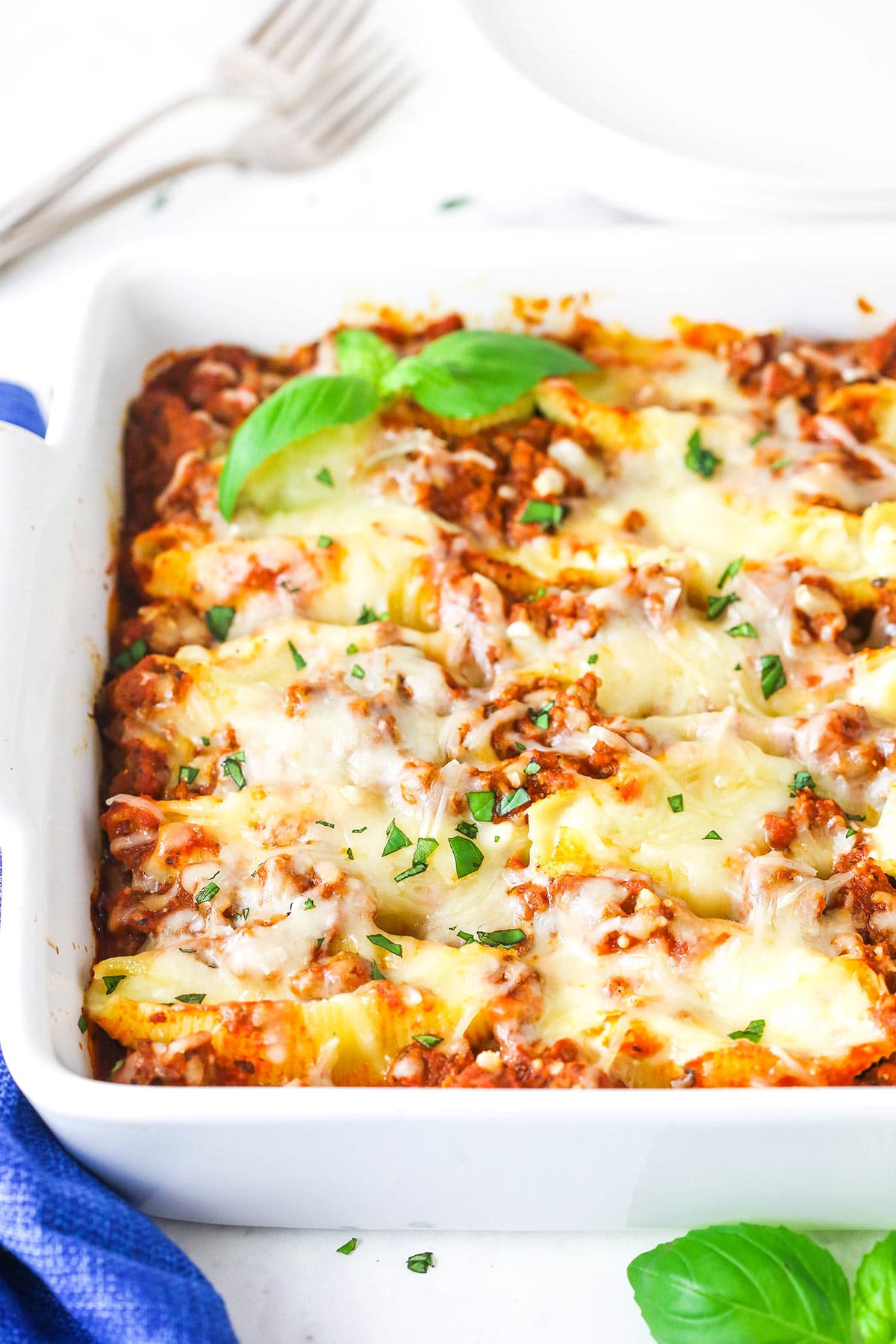 Beefy Italian stuffed shells in a white baking dish