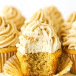 An unwrapped peanut butter cupcake with a bite taken out to reveal the fluffy interior