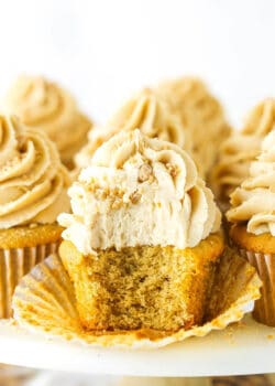 An unwrapped peanut butter cupcake with a bite taken out to reveal the fluffy interior