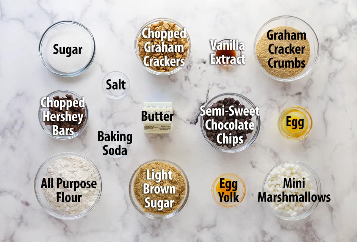 Every bite of these s’mores cookies is loaded with rich chocolate, gooey marshmallows, and sweet graham crackers. Overhead view of ingredients needed to make s'mores cookies
