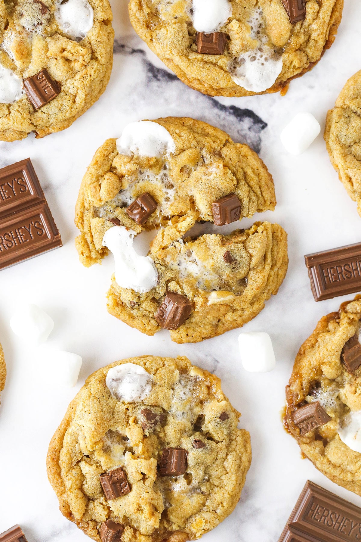 S'mores cookie broken in half with other cookies around it.