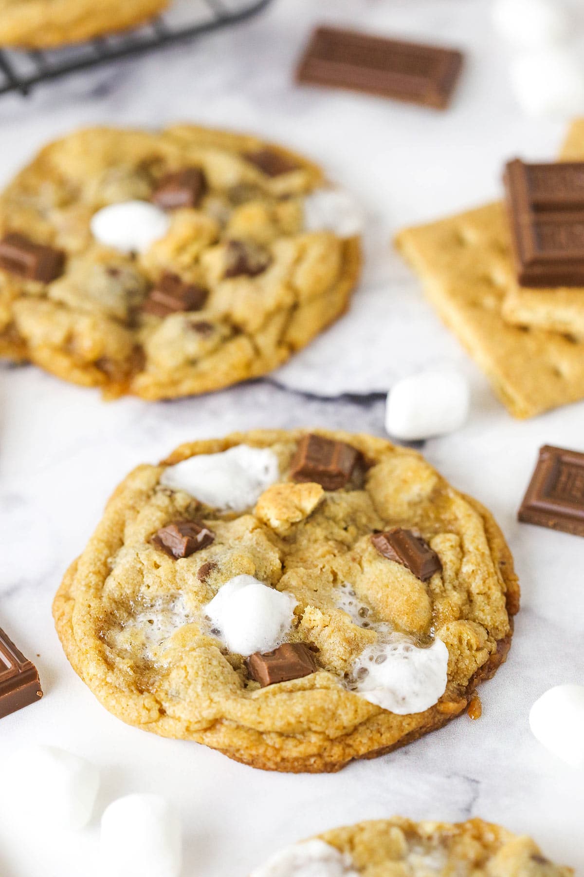 Two s'mores cookies on a marble table.