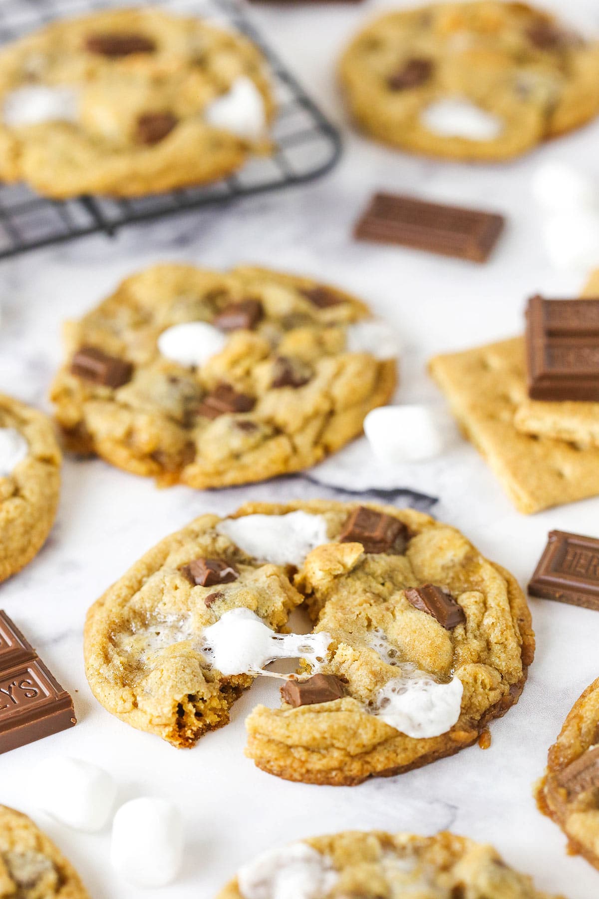 A broken s'mores cookie with melted marshmallows.