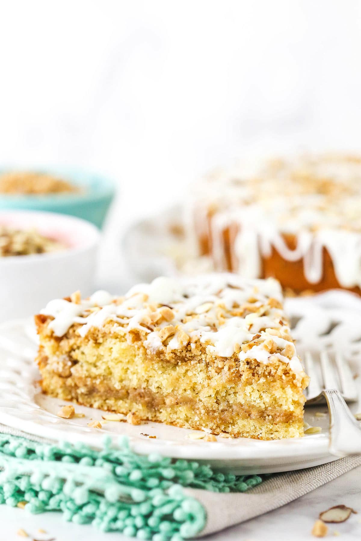 One serving of homemade coffee cake on a white plate with a fork