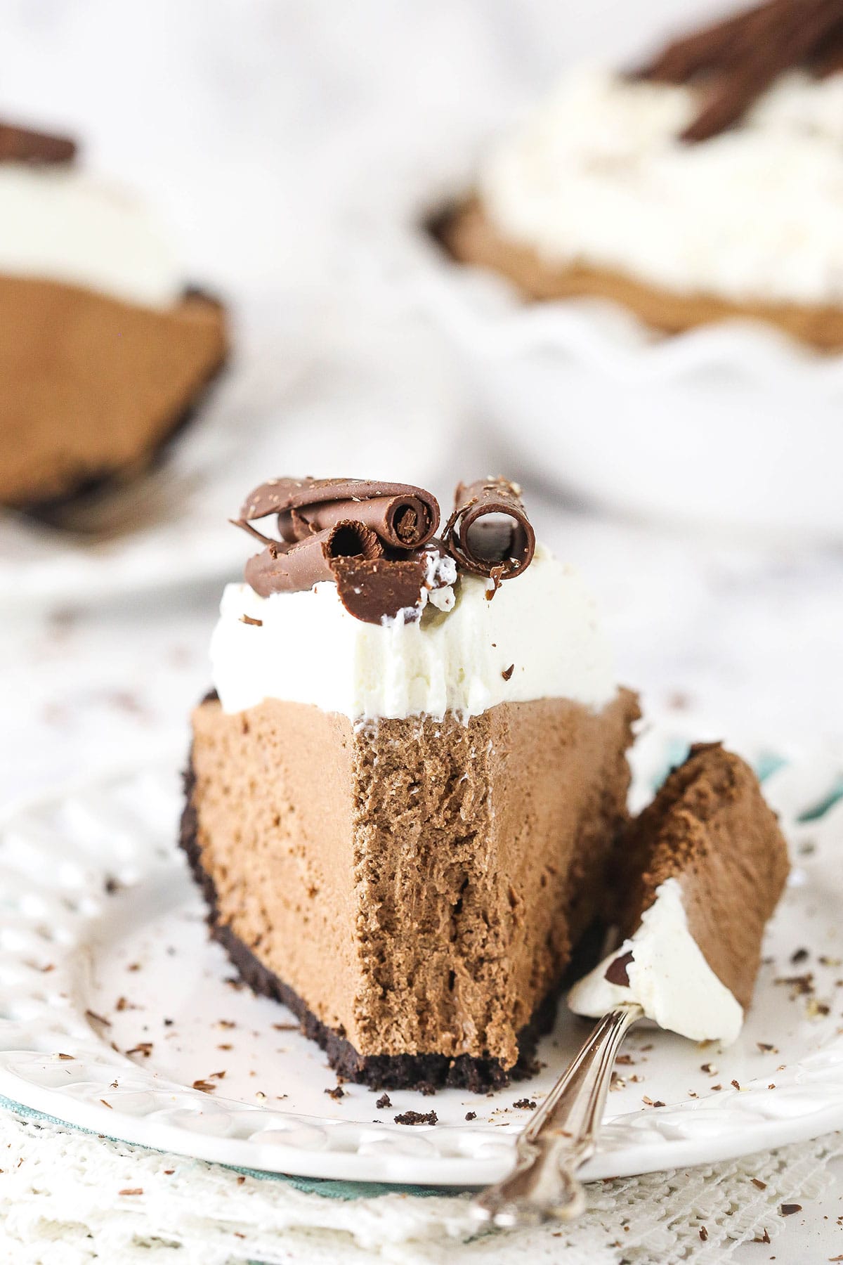 slice of french silk pie on white plate with a bite taken out