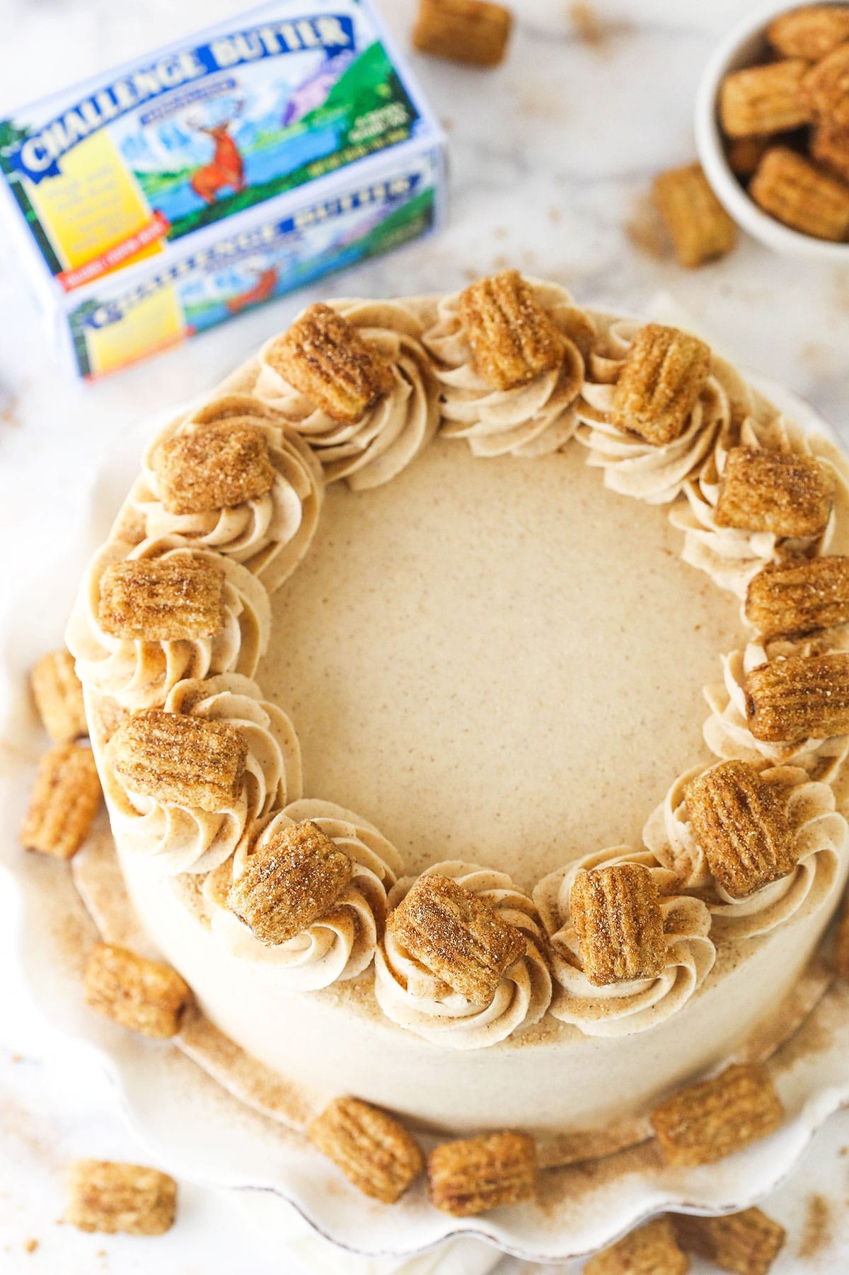 overhead image of churro layer cake with challenge butter next to it