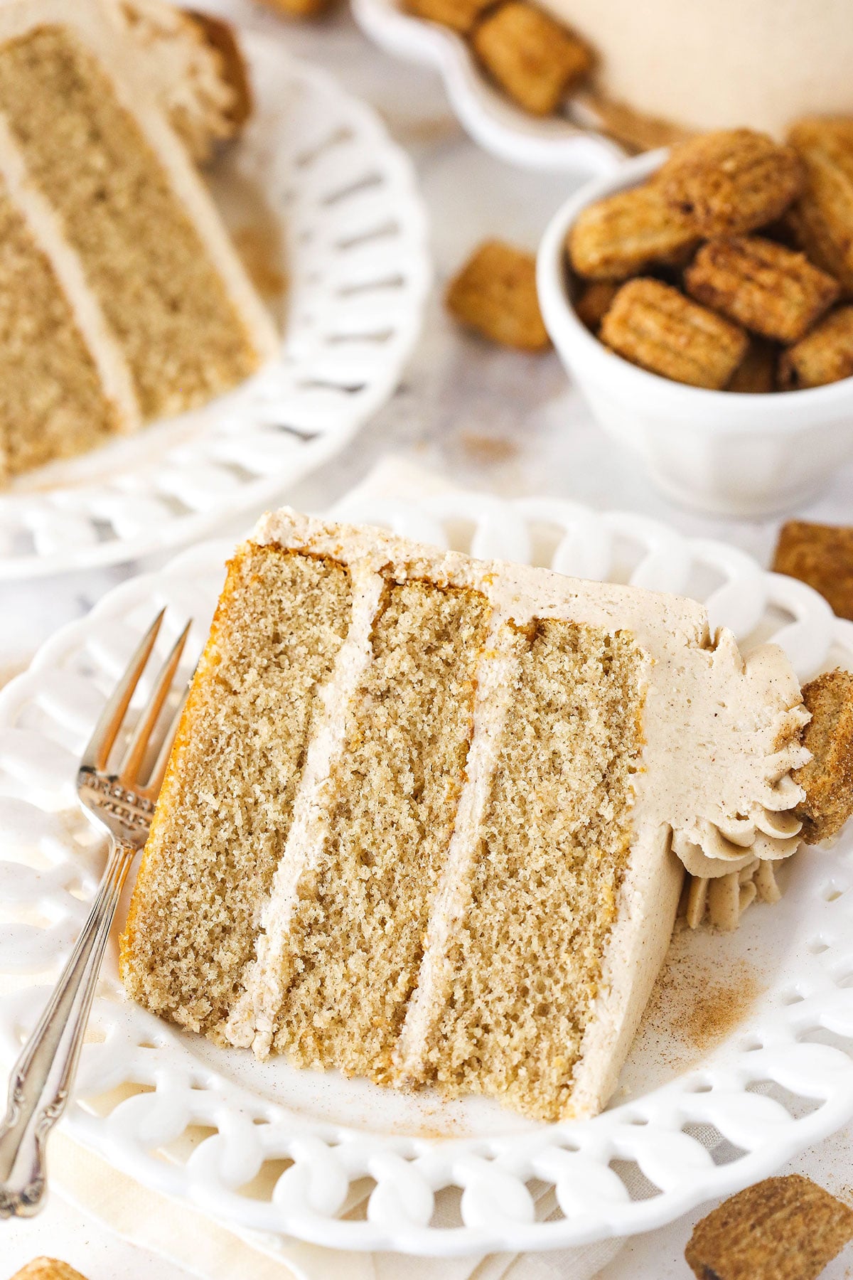 slice of churro layer cake on white plate