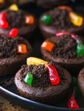 A close-up shot of Halloween worm and dirt cookies on a rimmed cookie tray