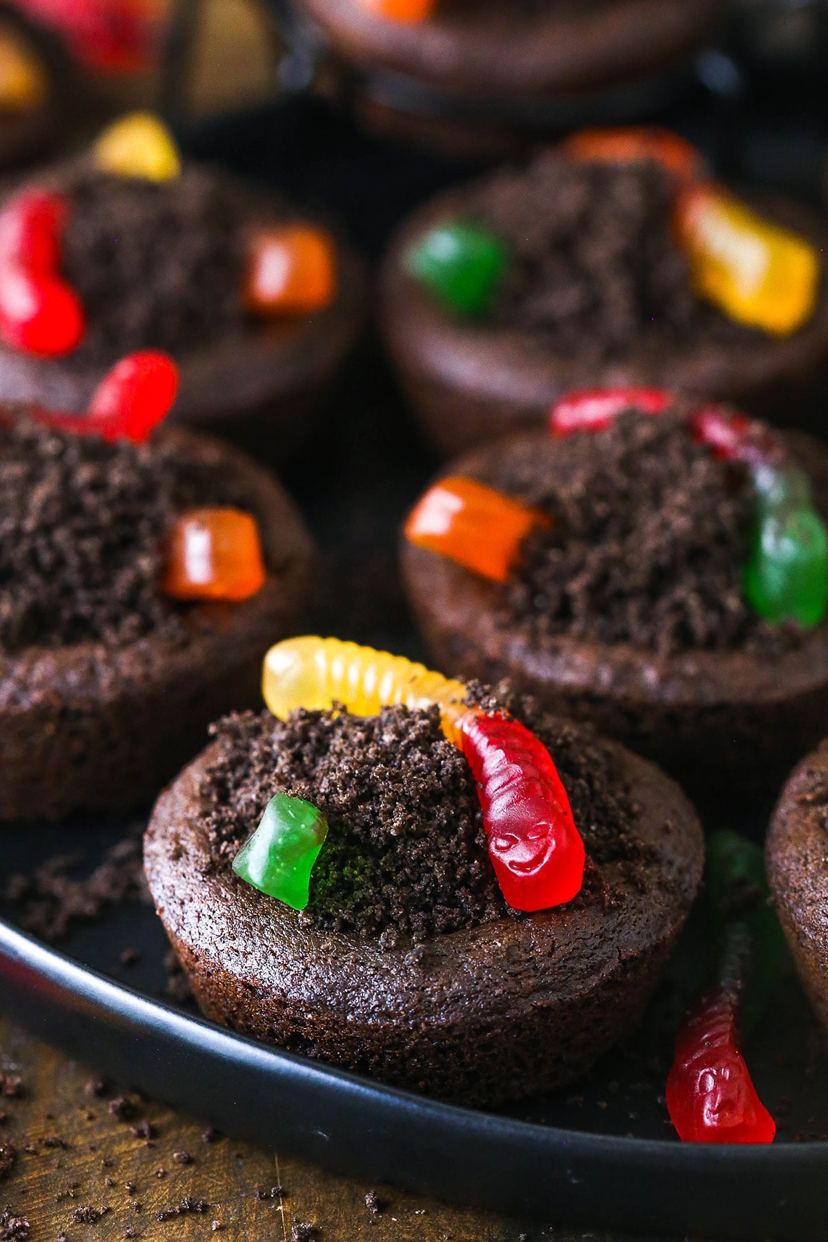 A close-up shot of Halloween worm and dirt cookies on a rimmed cookie tray