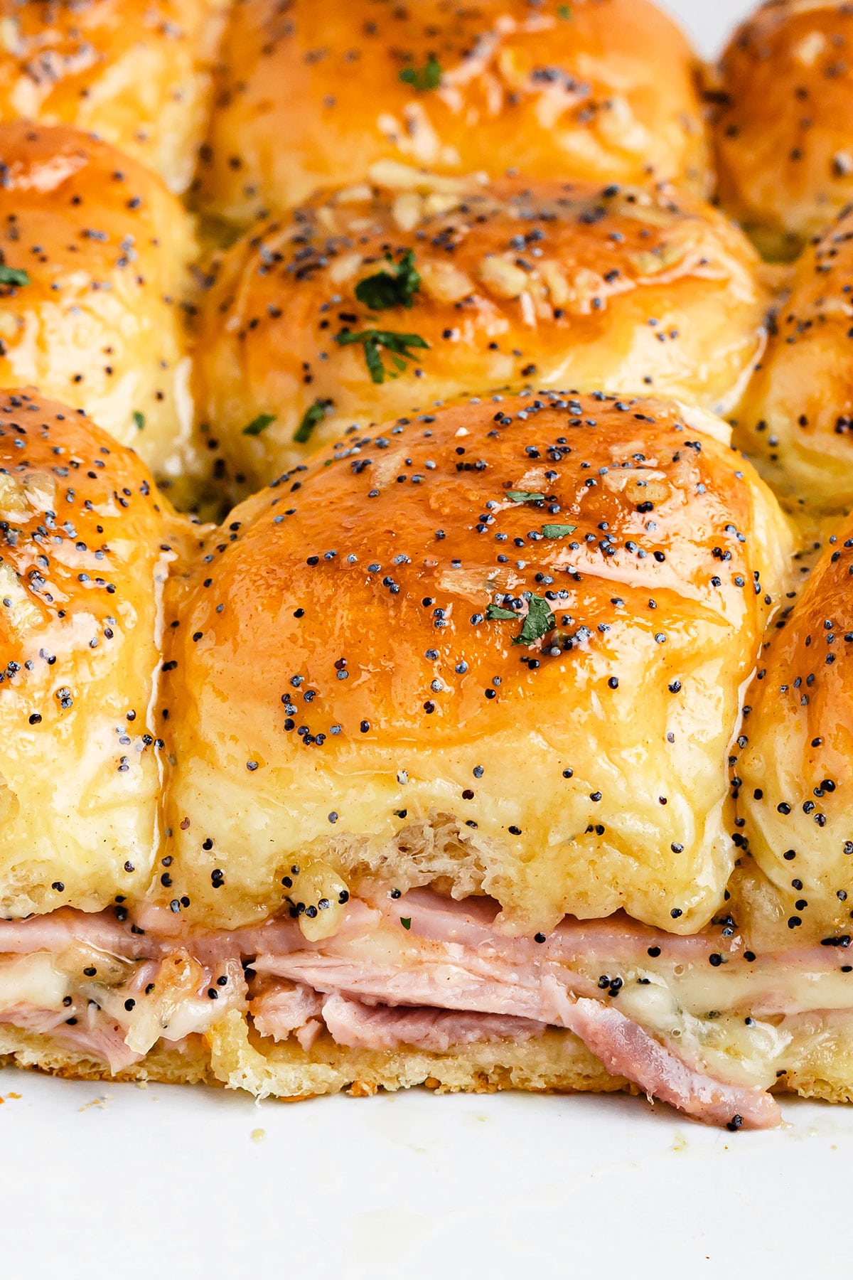 A batch of Hawaiian roll sliders inside of a baking dish